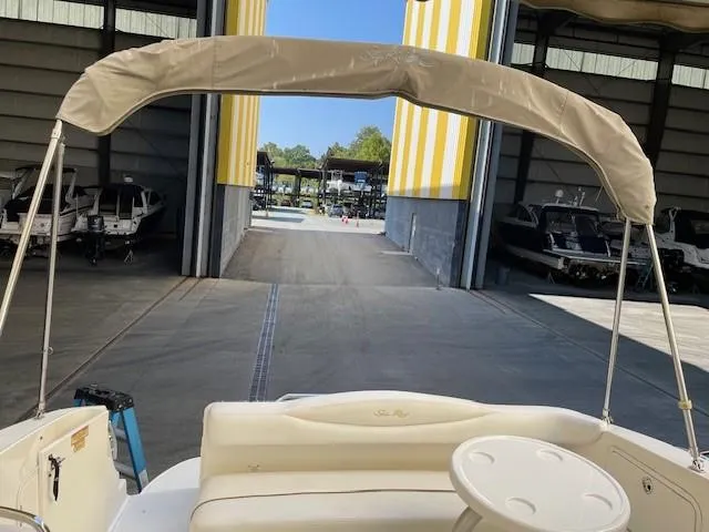 Slide: The Image of 2001 Sea Ray 280 Sundancer in storage facility with canopy and seating visible. - 7