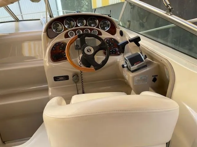 Slide: The Image of 2001 Sea Ray 280 Sundancer helm with gauges and steering wheel. - 9