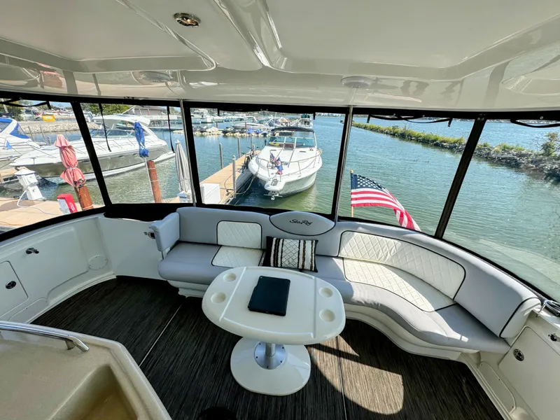 Slide: The Image of 2005 Sea Ray 390 Motor Yacht interior with seating, table, and marina view. - 14