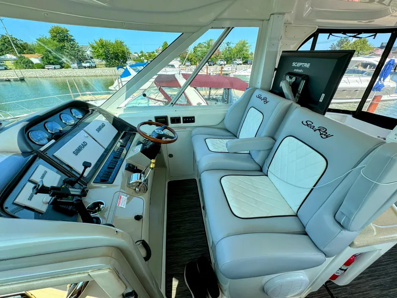 Slide: The Image of 2005 Sea Ray 390 Motor Yacht helm with dual seats and navigation equipment. - 16