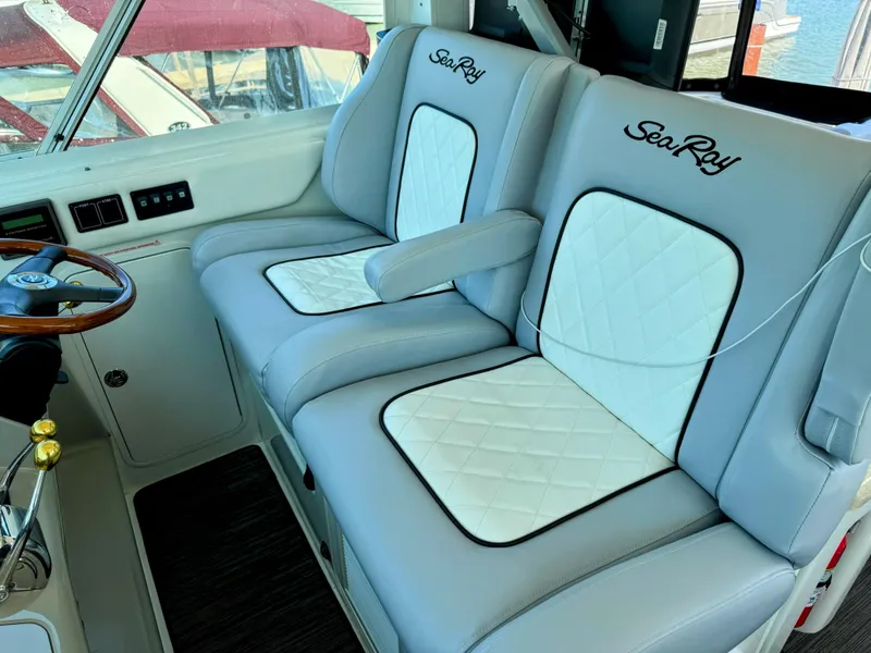 Slide: The Image of Luxurious seating in 2005 Sea Ray 390 Motor Yacht cockpit, featuring elegant white and gray upholstery. - 17