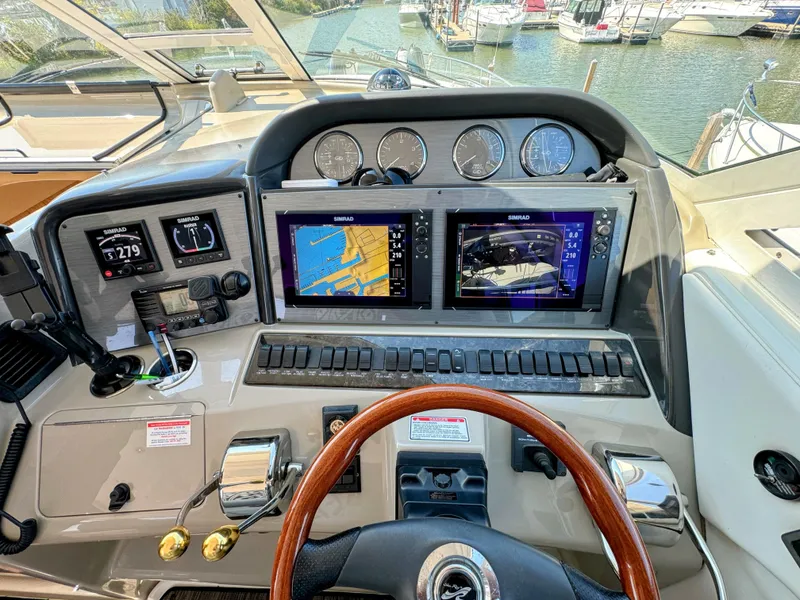 Slide: The Image of 2005 Sea Ray 390 Motor Yacht helm with navigation screens and controls. - 18