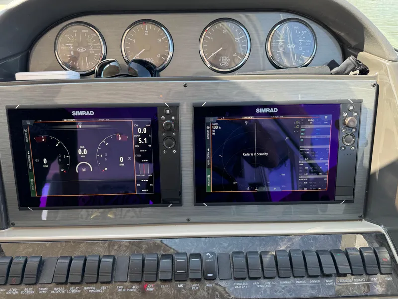 Slide: The Image of 2005 Sea Ray 390 Motor Yacht dashboard with Simrad navigation displays and control panel. - 22