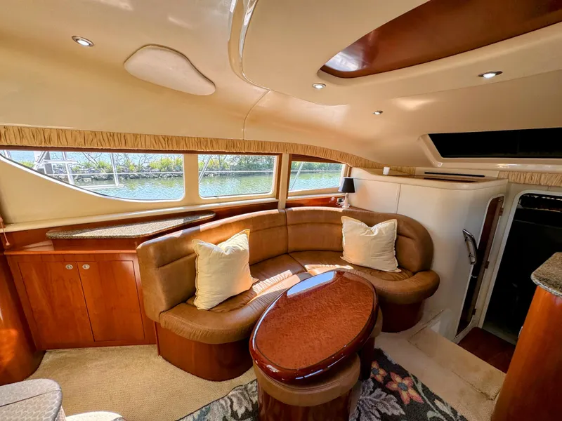 Slide: The Image of Luxurious 2005 Sea Ray 390 Motor Yacht interior with elegant seating and wood finishes. - 28