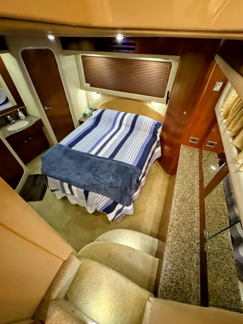 Slide: The Image of Interior cabin of 2005 Sea Ray 390 Motor Yacht with striped bedding. - 38