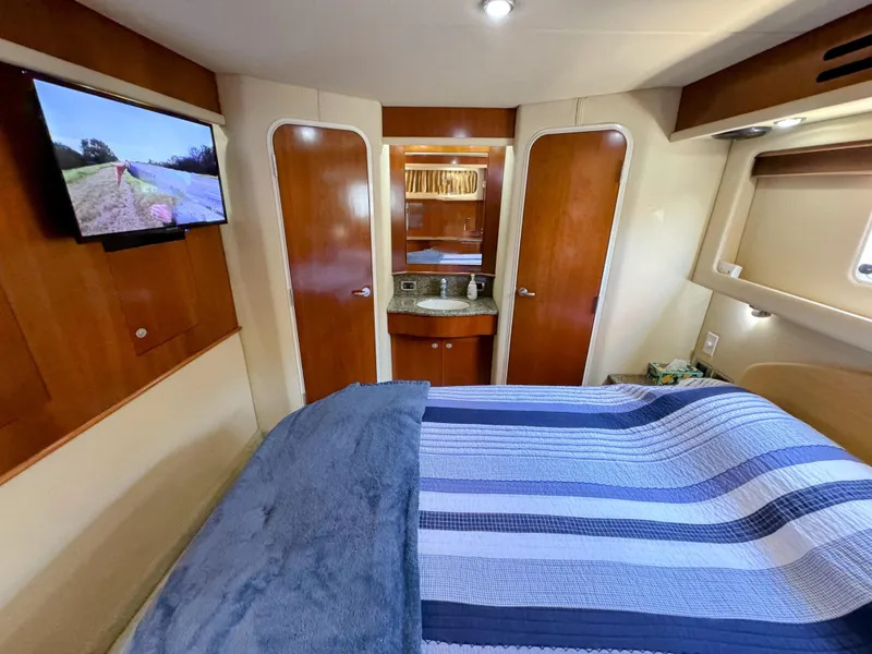 Slide: The Image of Luxurious 2005 Sea Ray 390 Motor Yacht bedroom with TV and ensuite bathroom. - 40