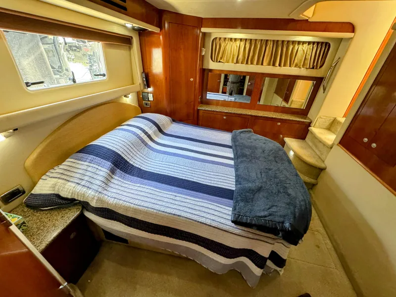 Slide: The Image of Luxurious bedroom interior of 2005 Sea Ray 390 Motor Yacht with striped bedding. - 43
