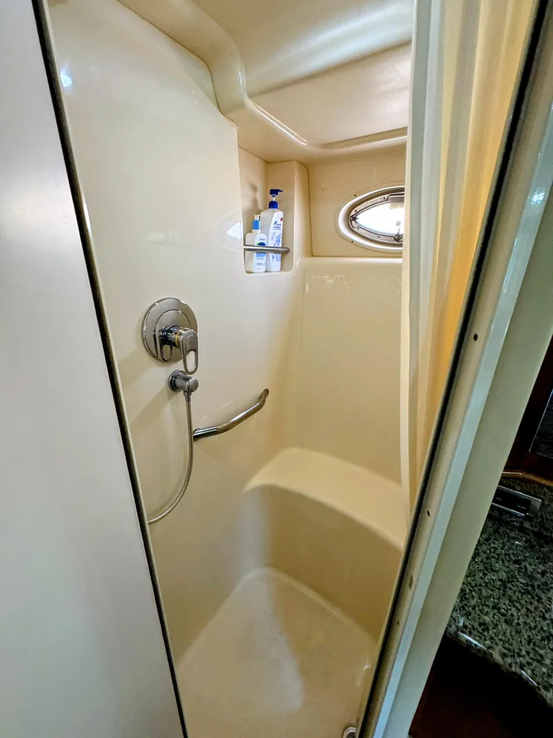 Slide: The Image of Shower area in 2005 Sea Ray 390 Motor Yacht with porthole and toiletries. - 44