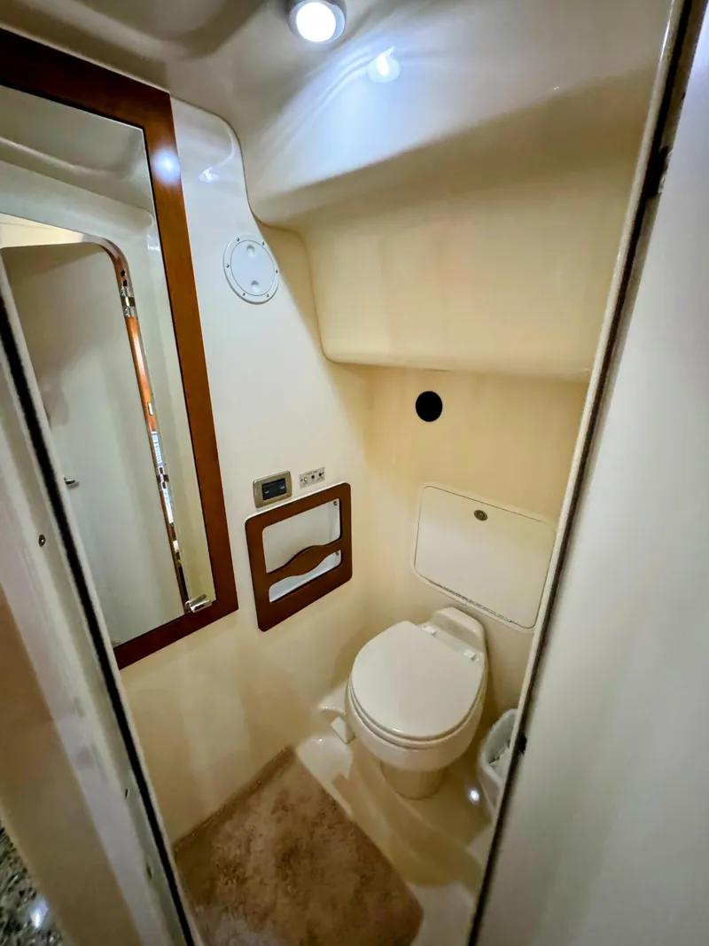 Slide: The Image of 2005 Sea Ray 390 Motor Yacht bathroom interior with modern fixtures and lighting. - 45