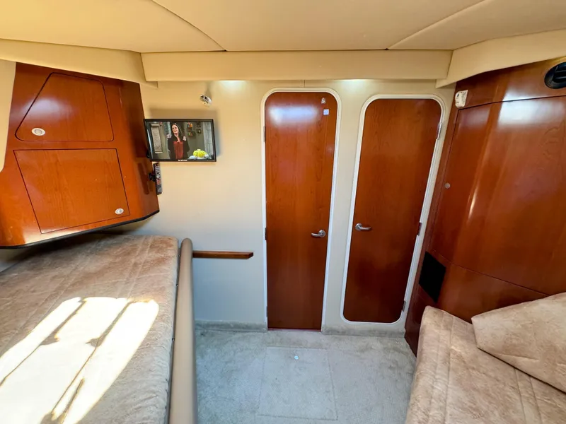 Slide: The Image of Interior of 2005 Sea Ray 390 Motor Yacht with wood cabinetry and cozy seating. - 48