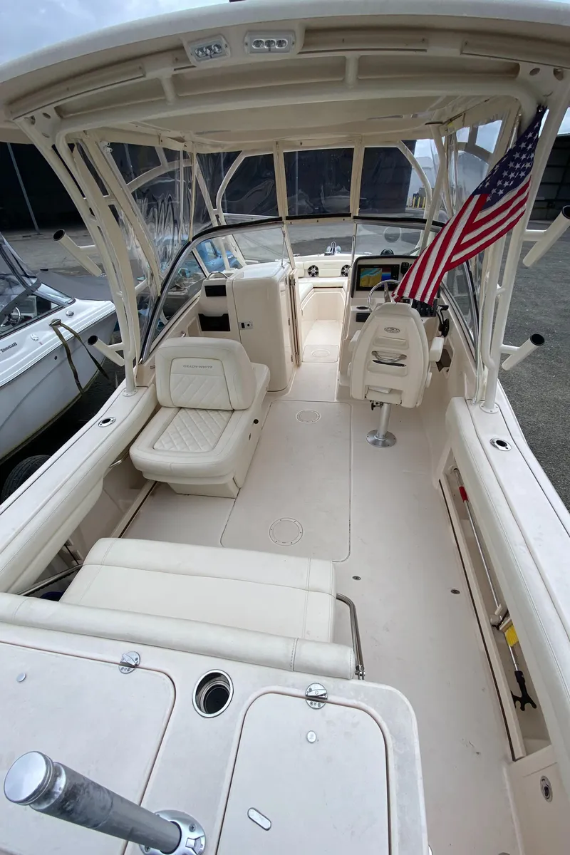 Slide: The Image of 2022 Grady-White Freedom 235 boat interior with seating and American flag. - 11