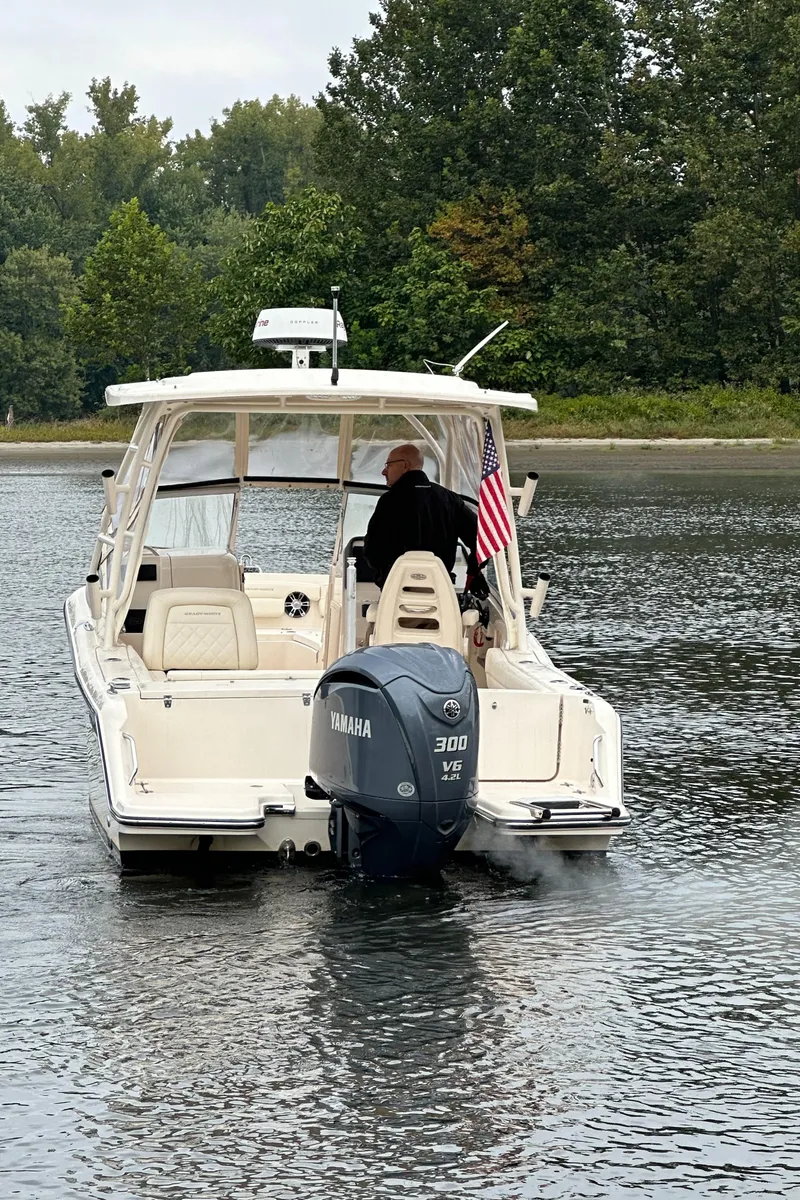 Slide: The Image of 2022 Grady-White Freedom 235 boat on water, rear view with Yamaha engine. - 3