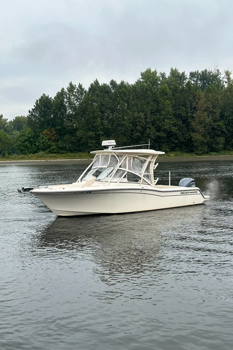 Slide: The Image of 2022 Grady-White Freedom 235 boat cruising on a calm lake. - 7