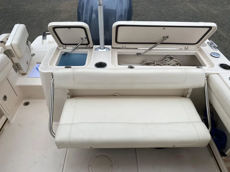Slide: The Image of 2022 Grady-White Freedom 235 boat interior with storage compartments and seating. - 8