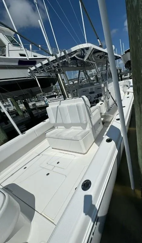 Slide: The Image of 2019 Invincible 36 Open Fisherman boat docked at marina under clear sky. - 13