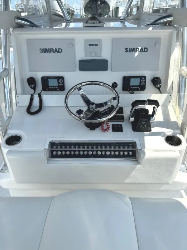 Slide: The Image of 2019 Invincible 36 Open Fisherman helm with Simrad electronics and dual cup holders. - 16