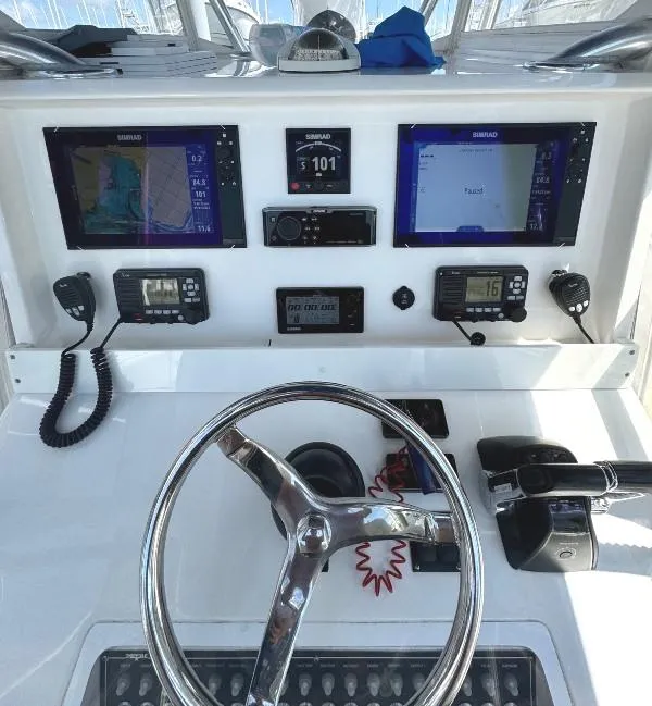 Slide: The Image of 2019 Invincible 36 Open Fisherman dashboard with navigation screens and controls. - 17