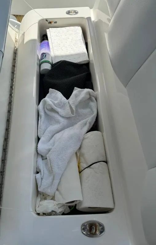 Slide: The Image of Storage compartment on 2019 Invincible 36 Open Fisherman with towels and supplies. - 20