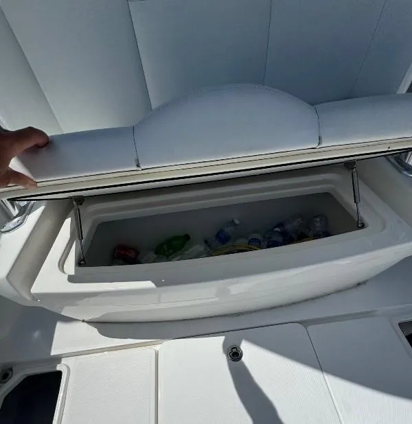 Slide: The Image of 2019 Invincible 36 Open Fisherman cooler with drinks inside, open seat storage. - 24