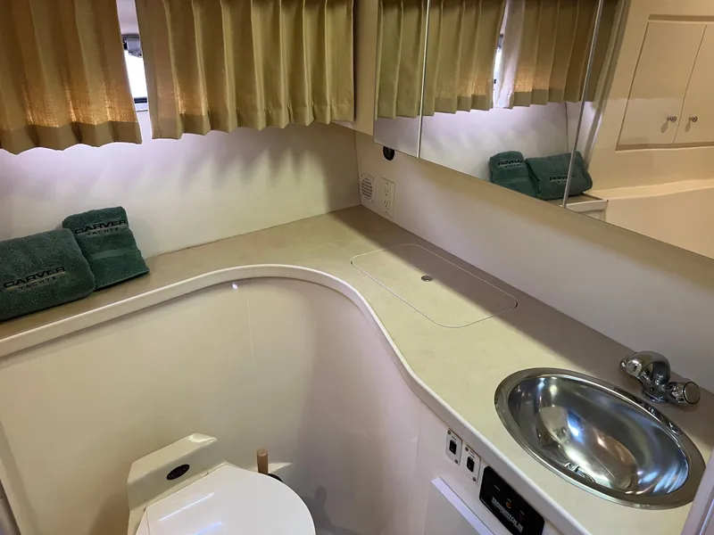 Slide: The Image of 1999 Carver 370 Voyager bathroom with sink, toilet, and mirror. - 19