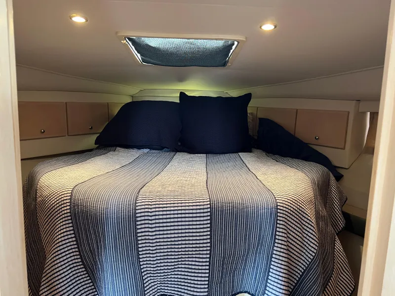 Slide: The Image of Cozy cabin bedroom in 1999 Carver 370 Voyager yacht with striped bedding. - 20