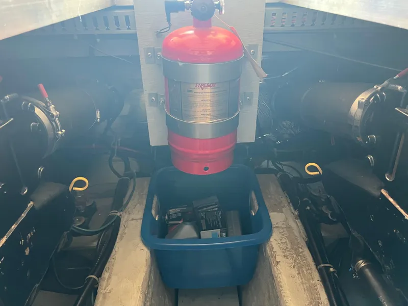 Slide: The Image of Engine room of 1999 Carver 370 Voyager with fire extinguisher and storage bin. - 24