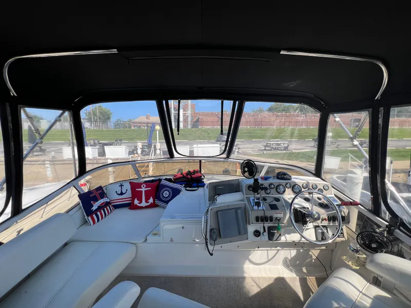 Slide: The Image of 1999 Carver 370 Voyager helm with nautical-themed cushions and panoramic windows. - 4