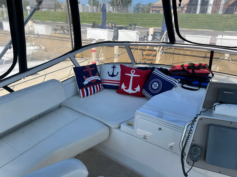 Slide: The Image of 1999 Carver 370 Voyager interior with nautical-themed cushions and navigation equipment. - 5