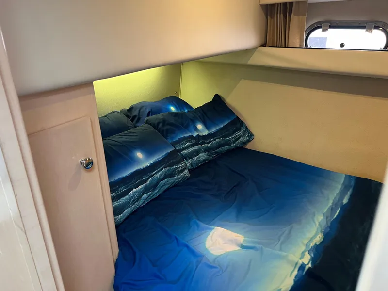 Slide: The Image of Cozy cabin bedroom in 1999 Carver 370 Voyager yacht with ocean-themed bedding. - 23