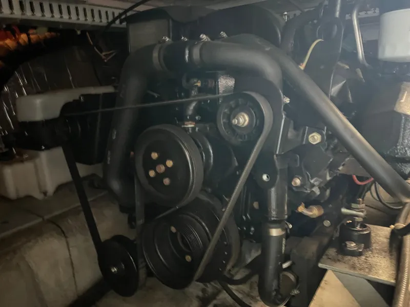 Slide: The Image of Engine of 1999 Carver 370 Voyager boat, showcasing belts and pulleys. - 25