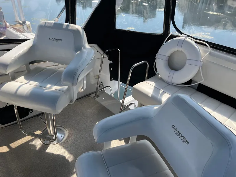Slide: The Image of Interior of 1999 Carver 370 Voyager with white seating and life preserver. - 7