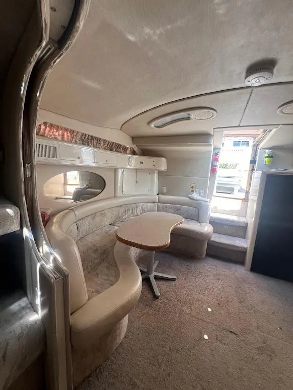 Slide: The Image of Interior of 1996 Sea Ray 400 Sundancer yacht with curved seating and table. - 10