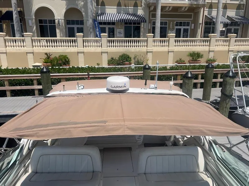 Slide: The Image of 1996 Sea Ray 400 Sundancer docked with tan canopy and Garmin radar. - 4