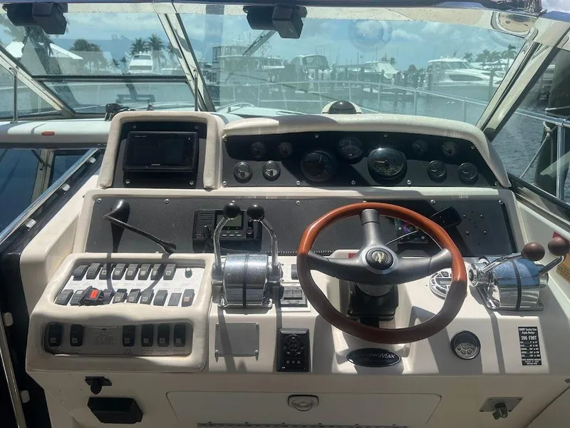 Slide: The Image of 1996 Sea Ray 400 Sundancer helm with steering wheel and control panel. - 5