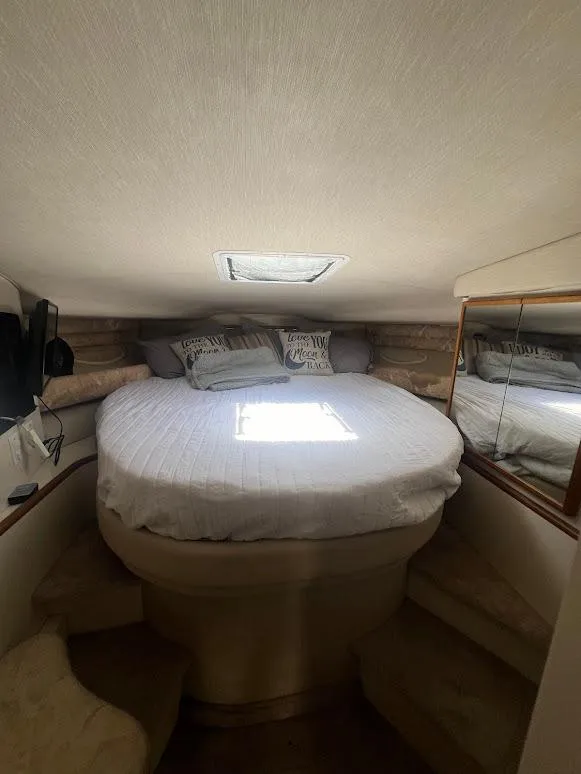 Slide: The Image of Cozy cabin interior of 1996 Sea Ray 400 Sundancer with round bed and skylight. - 9