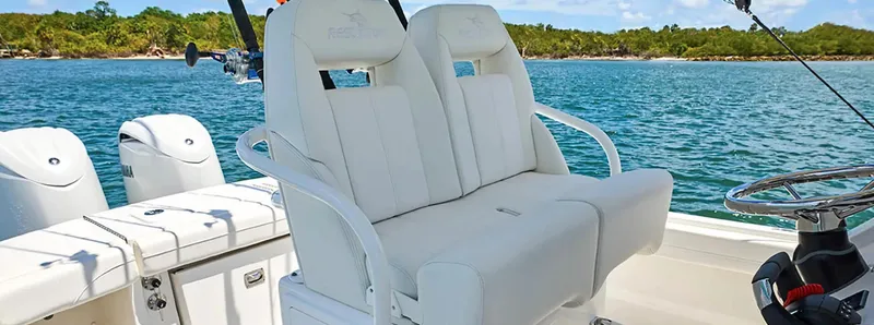 Slide: The Image of 2026 Regulator 23 boat with dual white seats on a sunny day. - 3