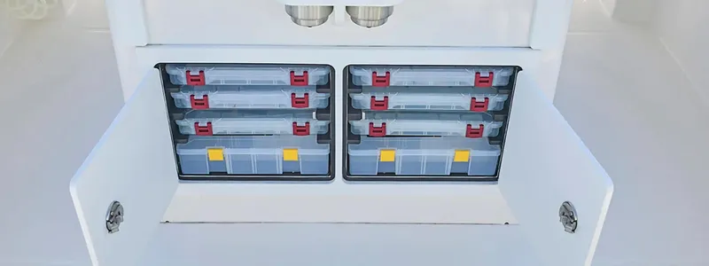 Slide: The Image of Storage compartments on a 2026 Regulator 23 boat, featuring organized tackle boxes. - 10