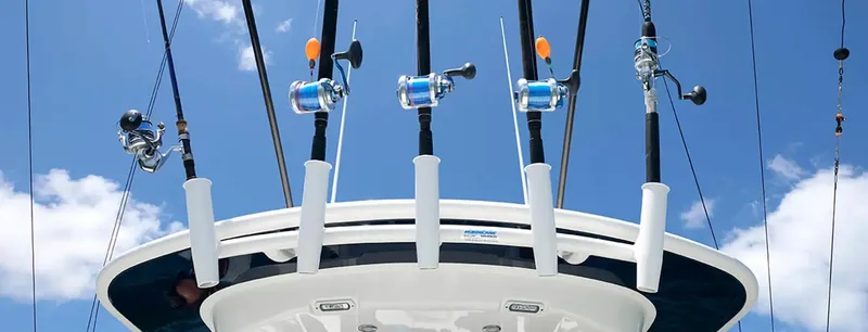 Slide: The Image of Fishing rods on a 2026 Regulator 23 boat against a clear blue sky. - 5
