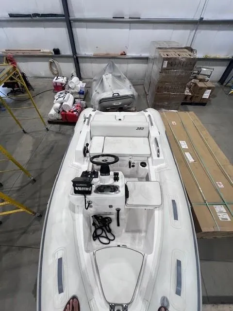Slide: The Image of 2023 AB Inflatables ABJET 350XP boat in a warehouse setting. - 5