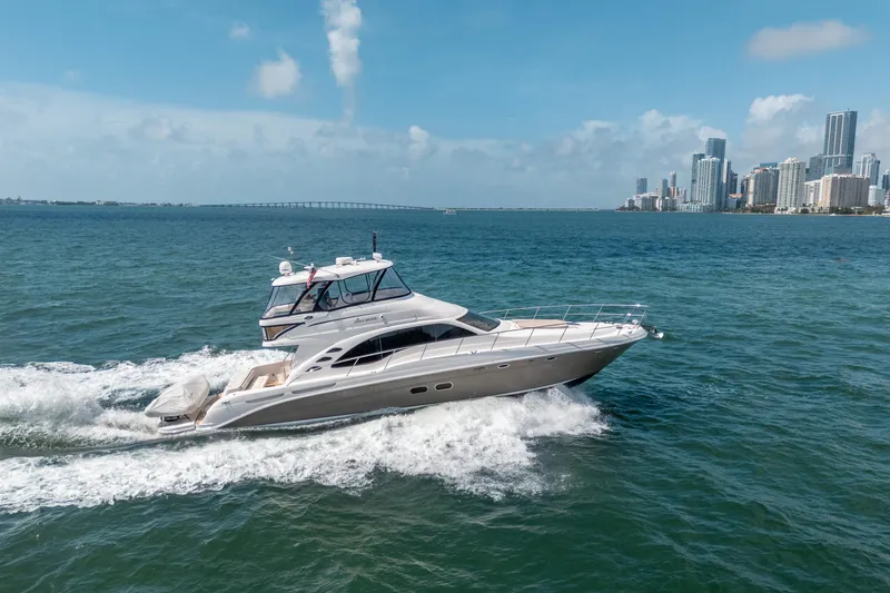 Slide: The Image of 2006 Sea Ray 58 Sedan Bridge yacht cruising near city skyline. - 13