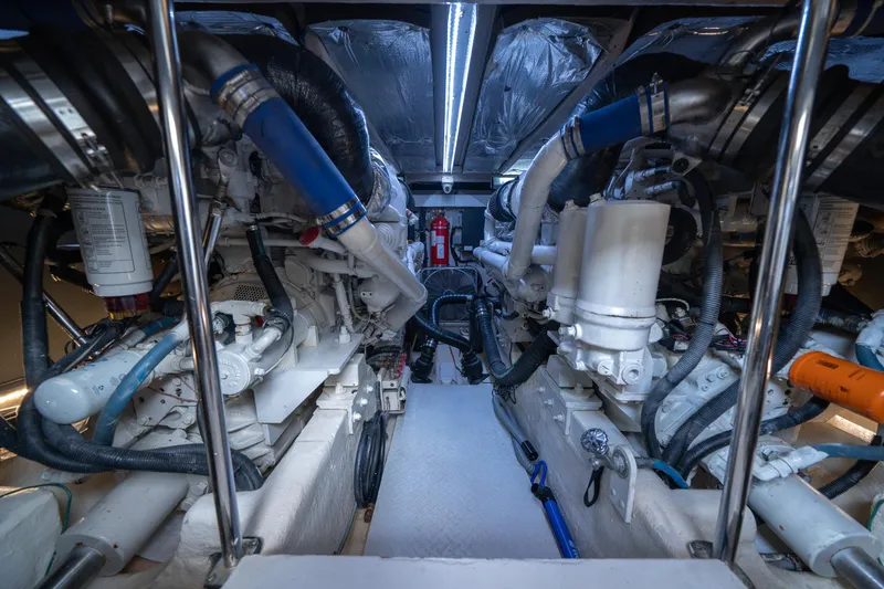 Slide: The Image of Engine room of 2006 Sea Ray 58 Sedan Bridge with visible machinery and pipes. - 20