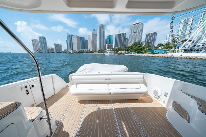 Slide: The Image of 2006 Sea Ray 58 Sedan Bridge yacht with city skyline view. - 21
