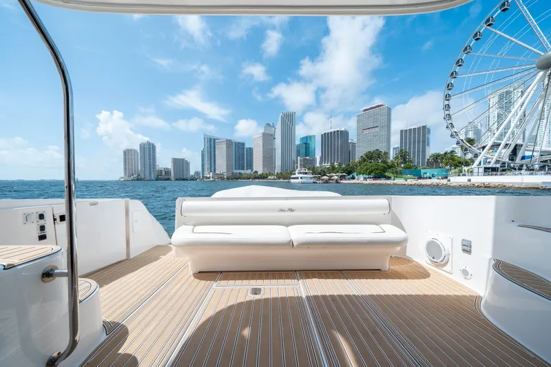 Slide: The Image of 2006 Sea Ray 58 Sedan Bridge yacht with city skyline and Ferris wheel view. - 22