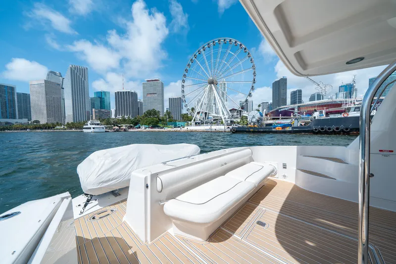 Slide: The Image of 2006 Sea Ray 58 Sedan Bridge yacht with city skyline and Ferris wheel in background. - 23