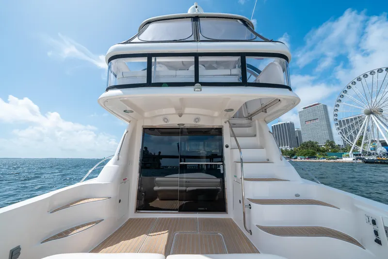 Slide: The Image of 2006 Sea Ray 58 Sedan Bridge yacht with cityscape and Ferris wheel in background. - 27