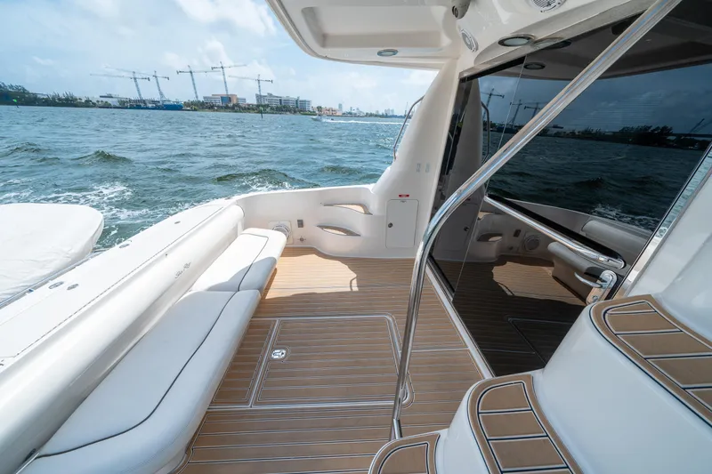 Slide: The Image of 2006 Sea Ray 58 Sedan Bridge yacht deck with ocean view and elegant seating. - 28