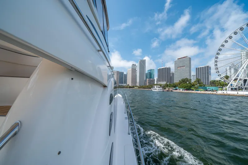 Slide: The Image of 2006 Sea Ray 58 Sedan Bridge cruising near city skyline and Ferris wheel. - 30