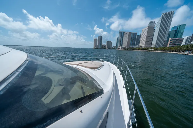 Slide: The Image of 2006 Sea Ray 58 Sedan Bridge cruising near city skyline on a sunny day. - 32