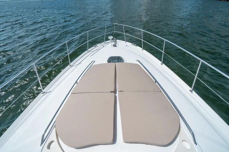 Slide: The Image of 2006 Sea Ray 58 Sedan Bridge yacht bow with sun pads on open water. - 33
