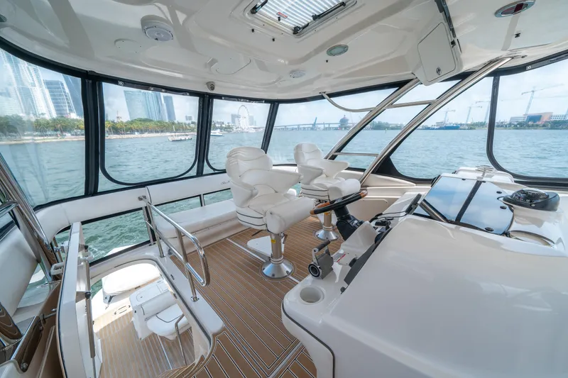 Slide: The Image of Luxurious 2006 Sea Ray 58 Sedan Bridge yacht interior with panoramic windows and plush seating. - 41